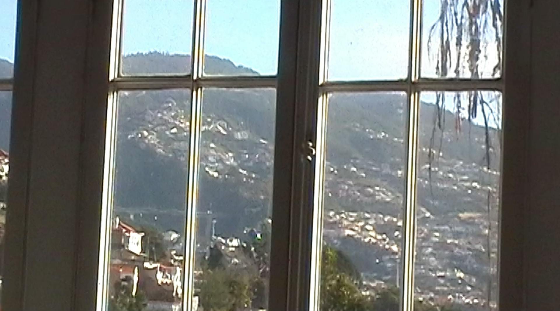 a window with a view of a mountain