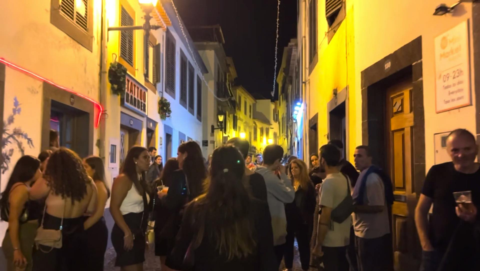 a group of people standing in a narrow street