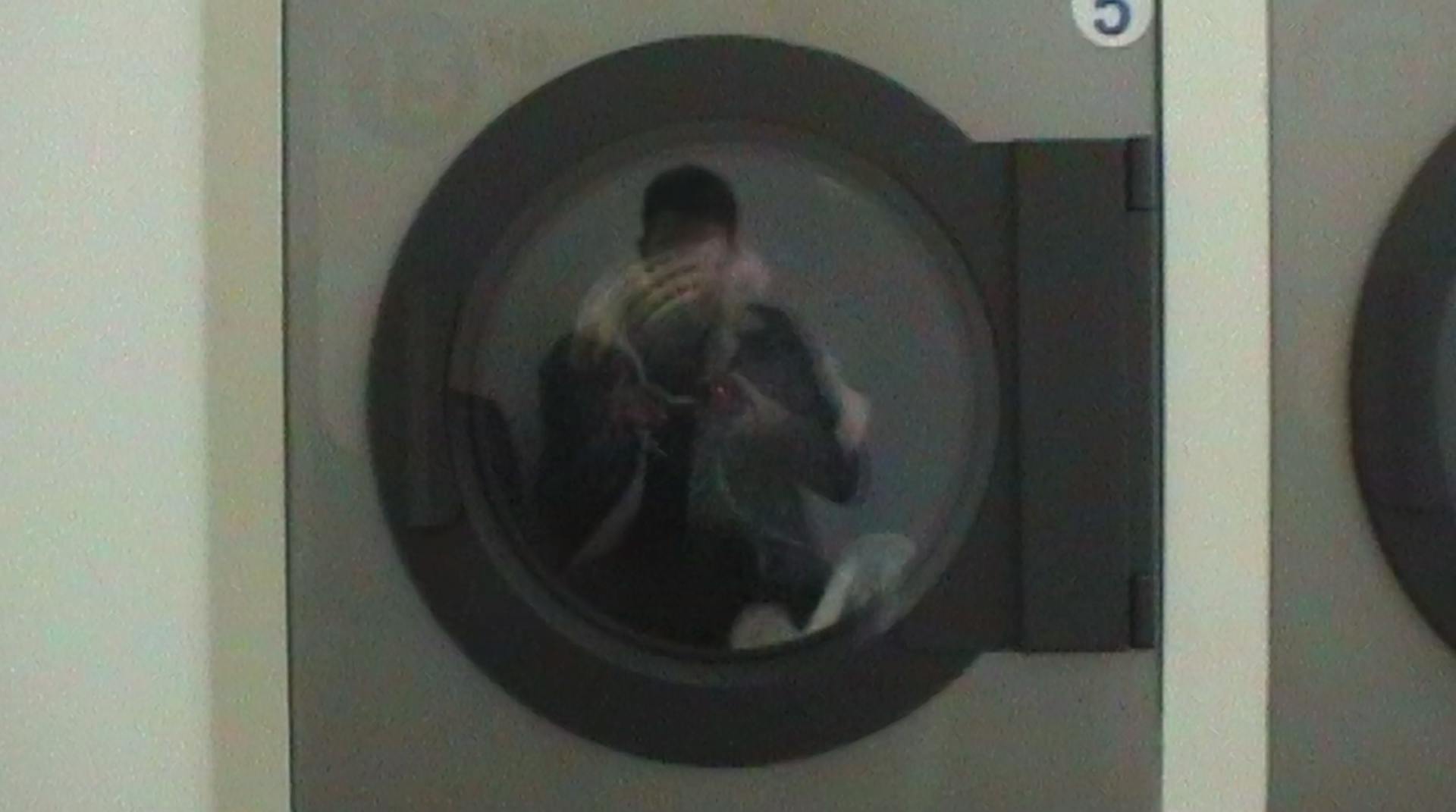 a reflection of a man in a washing machine