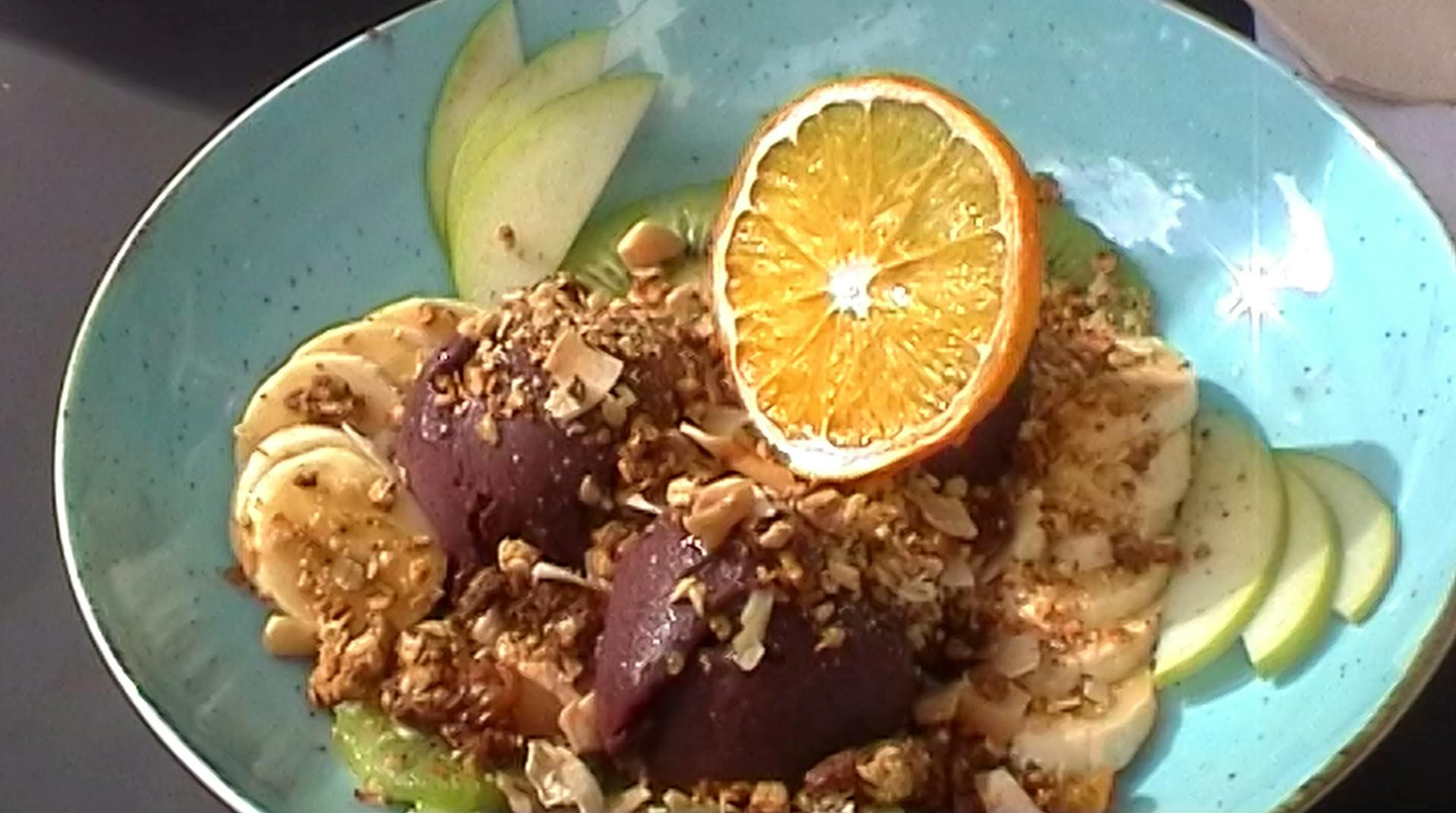 a blue plate topped with fruit and nuts