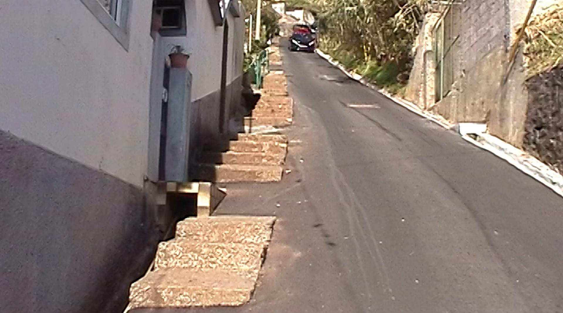 a narrow street with steps leading up to a building