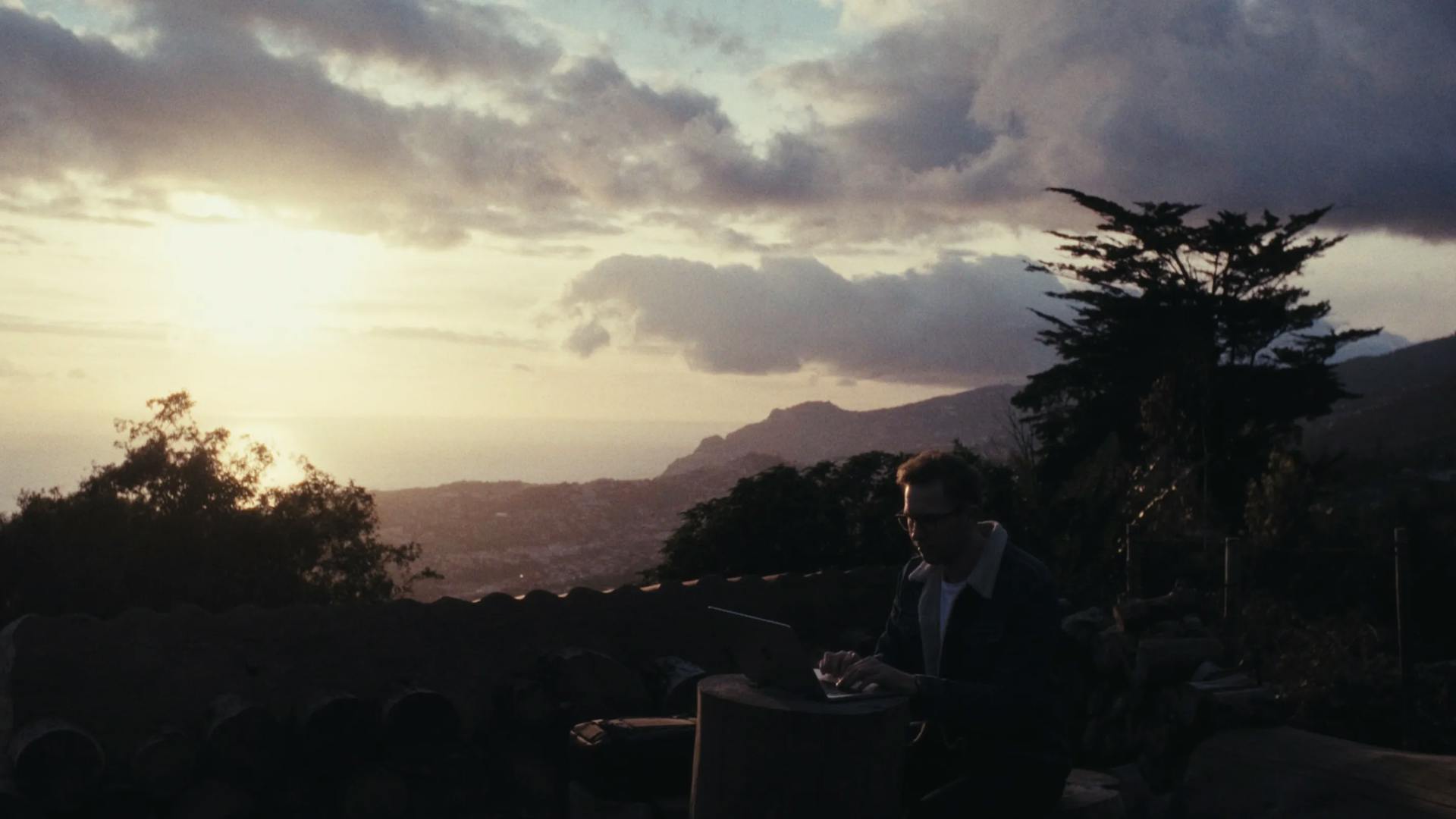 a man in a suit is sitting on a bench