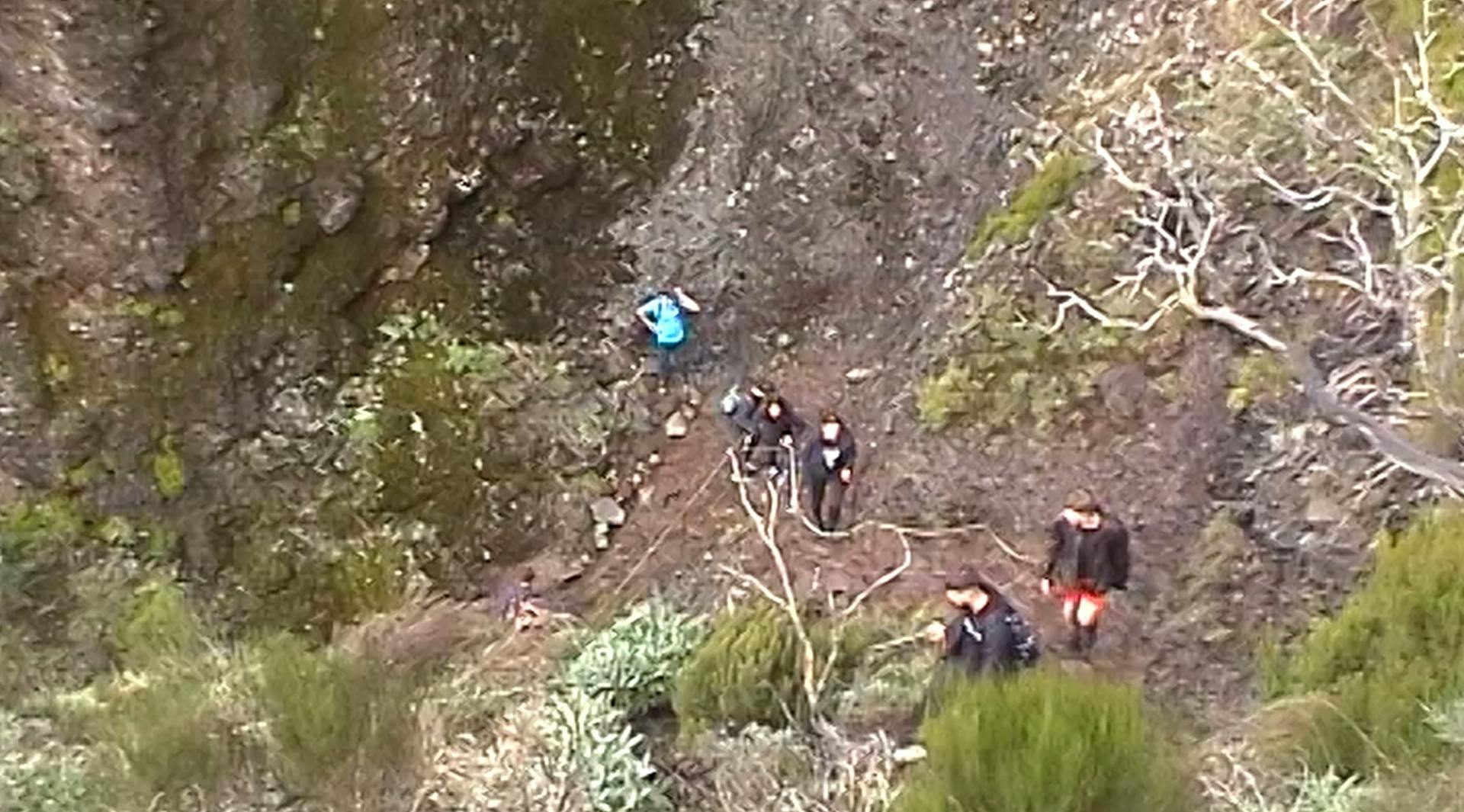 a group of people walking up a steep hill