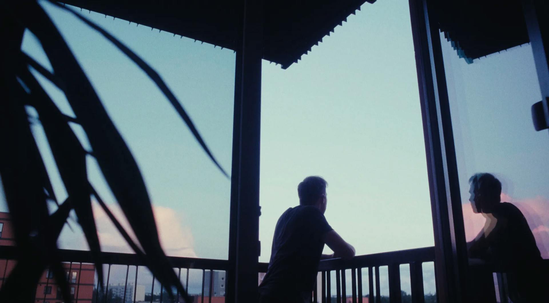 a couple of people that are standing on a balcony