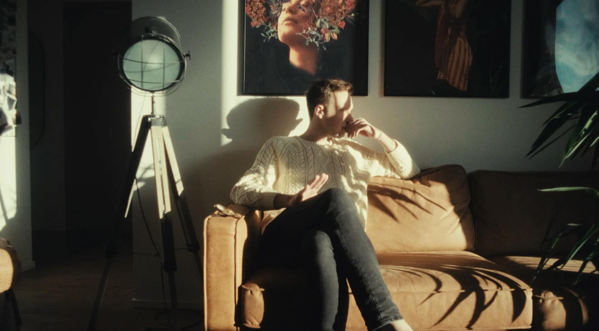 a man sitting on a couch in a living room