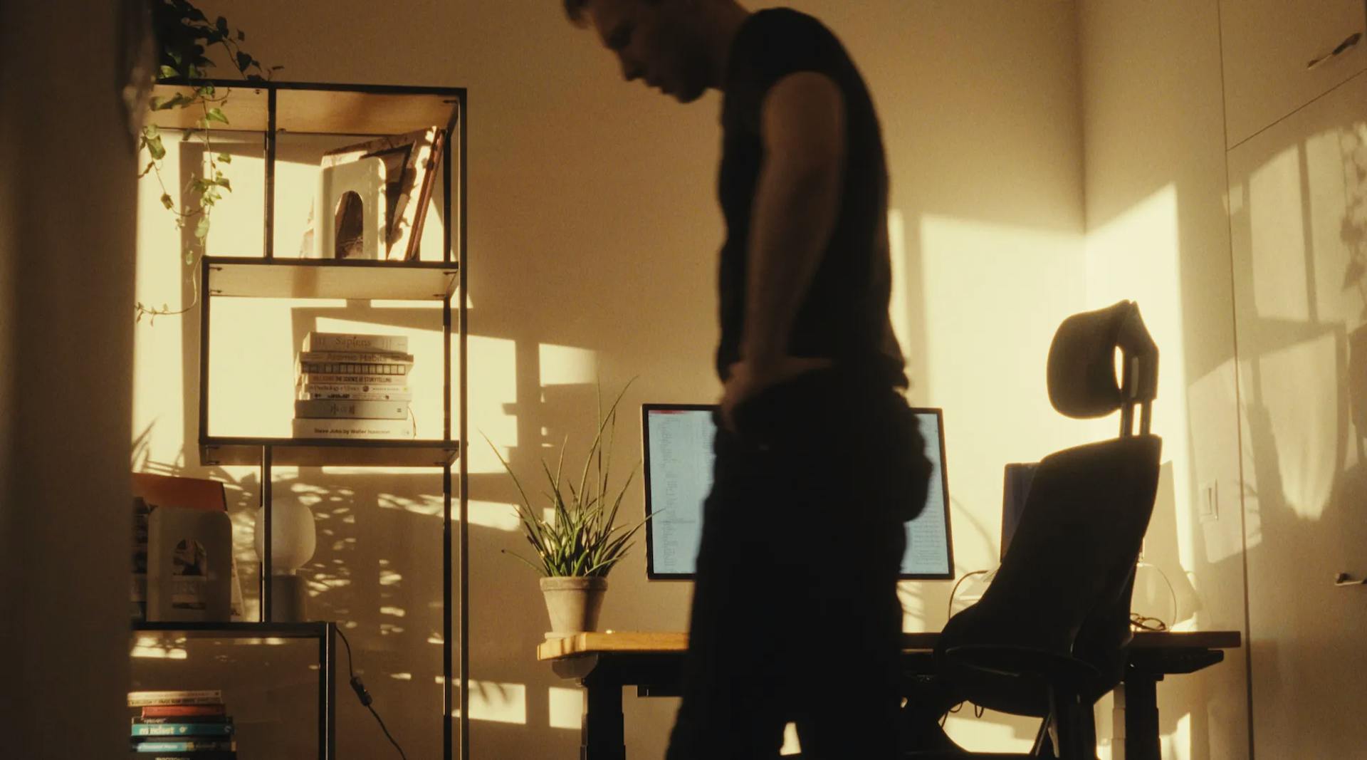 a man standing in front of a computer desk