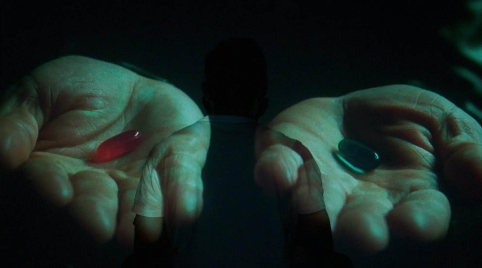 a person holding a red pill in their hands