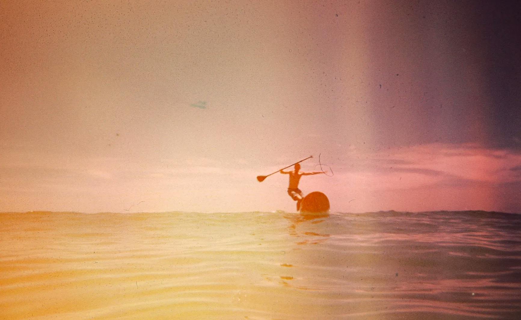 a person riding a surfboard on top of a body of water